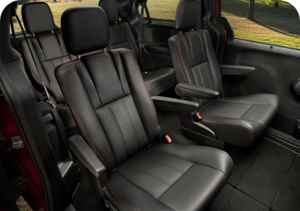 Black seats of car with safety belts and arm rests